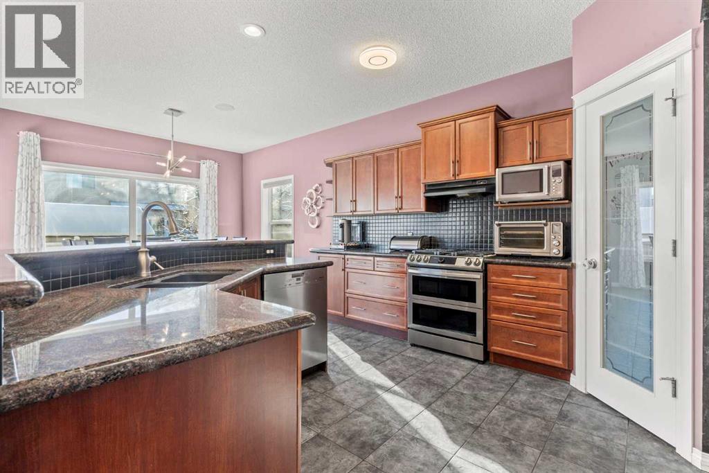 15 Chapalina Close Se, Calgary, AB - Indoor Photo Showing Kitchen With Stainless Steel Kitchen With Double Sink With Upgraded Kitchen