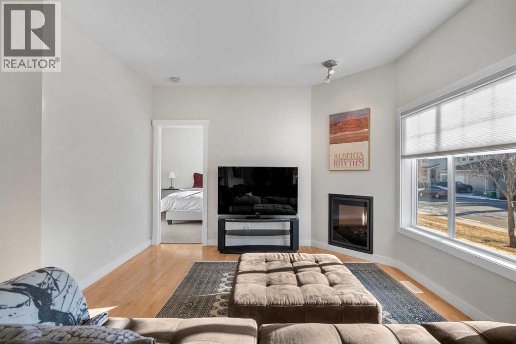 1101, 281 Cougar Ridge Drive Sw, Calgary, AB - Indoor Photo Showing Living Room With Fireplace