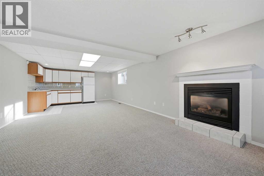 15 26534 Township Road 384, Rural Red Deer County, AB - Indoor Photo Showing Other Room With Fireplace