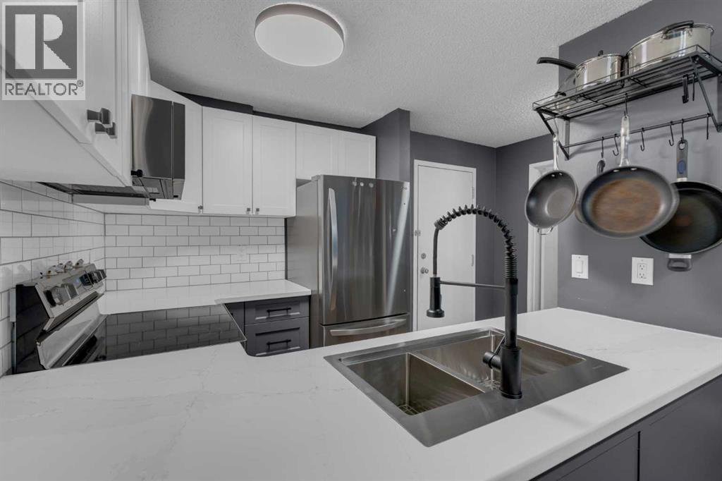 202, 1915 26 Street Sw, Calgary, AB - Indoor Photo Showing Kitchen With Stainless Steel Kitchen With Double Sink