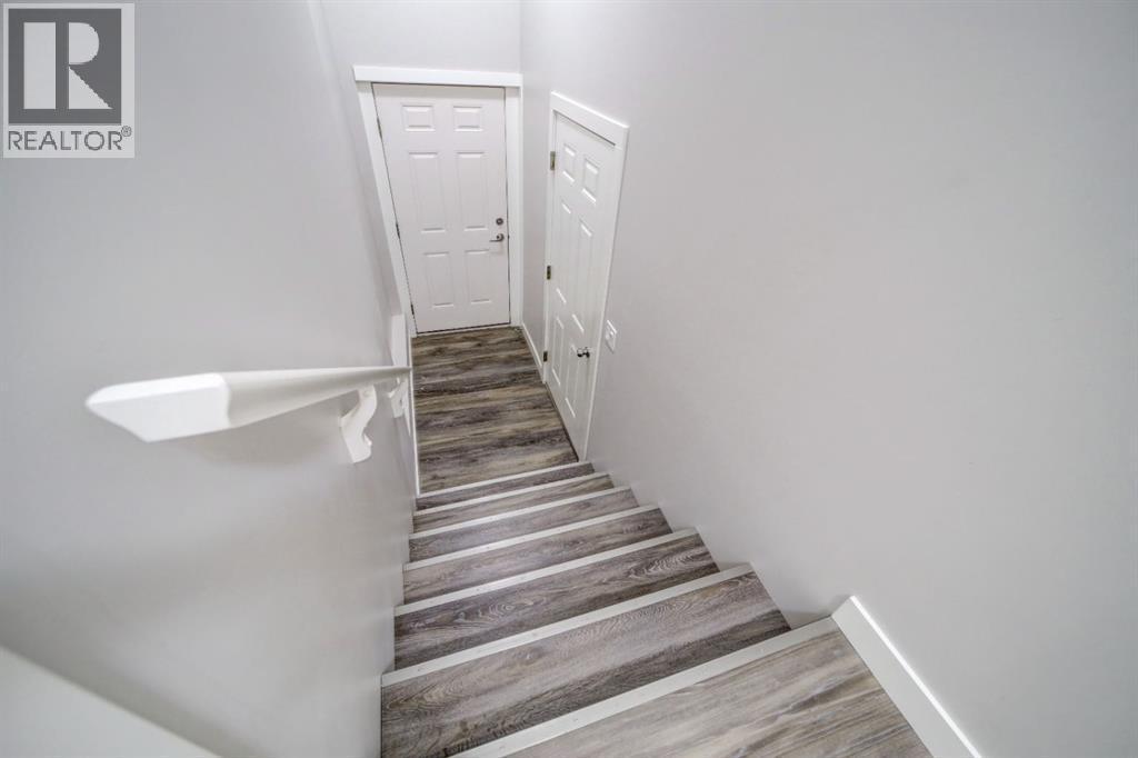 Garage Door + Exterior Man Door - 203 1 Street, Shaughnessy, AB - Indoor Photo Showing Other Room