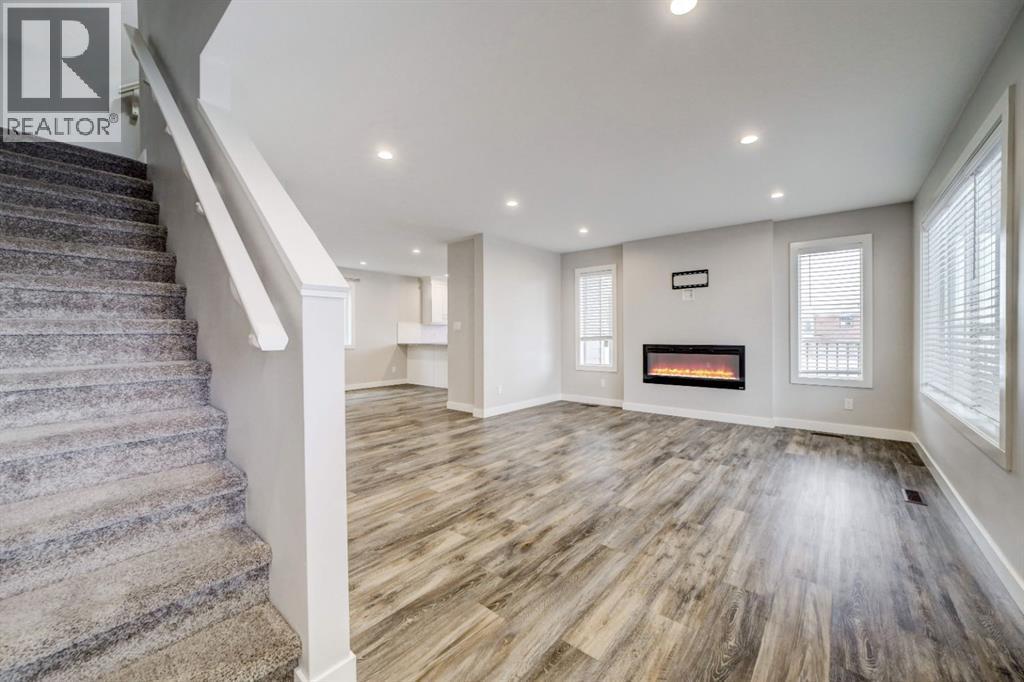 Entry Facing Living Room - 203 1 Street, Shaughnessy, AB - Indoor With Fireplace