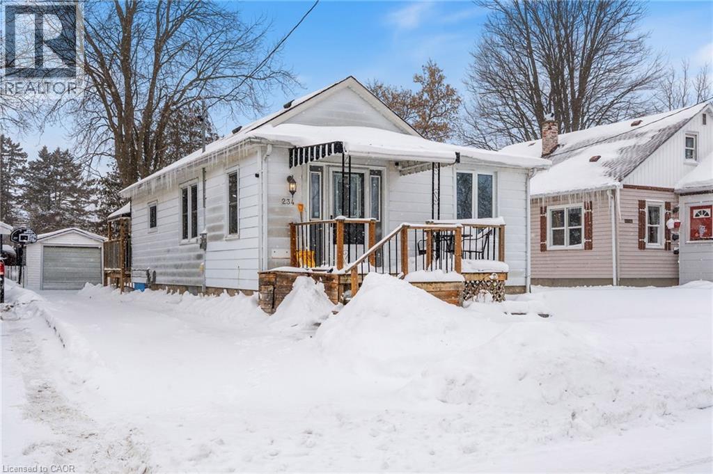 View of front of property featuring an outdoor structure, a chimney, and a garage - 234 Head Street N, Simcoe, ON - Outdoor