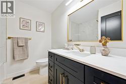 Bathroom with vanity, a shower, and light wood finished floors -