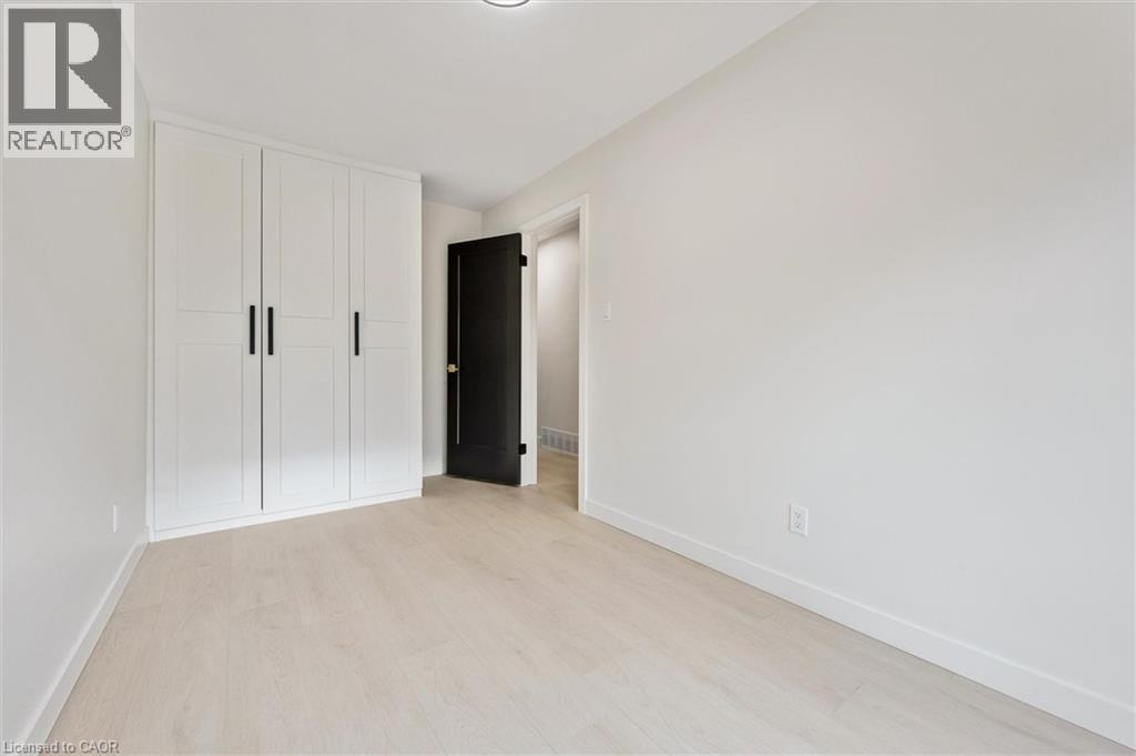 Unfurnished bedroom with a closet and light wood-style flooring - 459 Drummerhill Crescent, Waterloo, ON - Indoor Photo Showing Other Room
