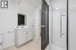 Bathroom featuring a shower stall and vanity -