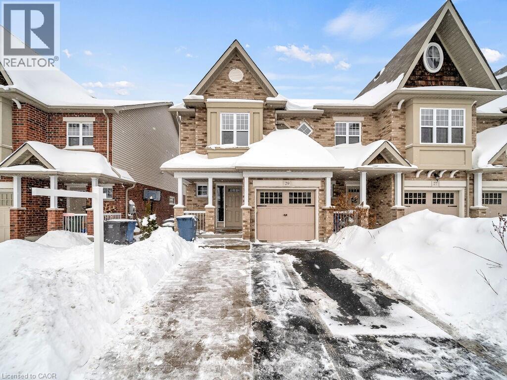 View of front of house with a porch and brick siding - 29 Amsterdam Crescent, Guelph, ON - Outdoor With Facade