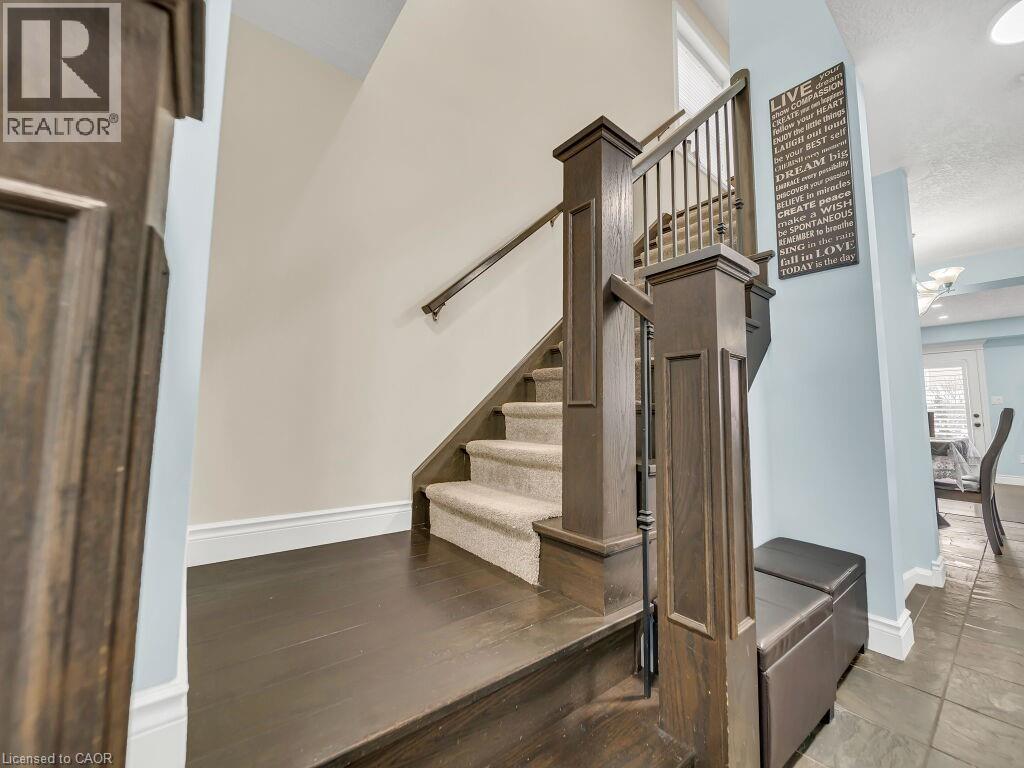 Staircase featuring baseboards and a high ceiling - 29 Amsterdam Crescent, Guelph, ON - Indoor Photo Showing Other Room