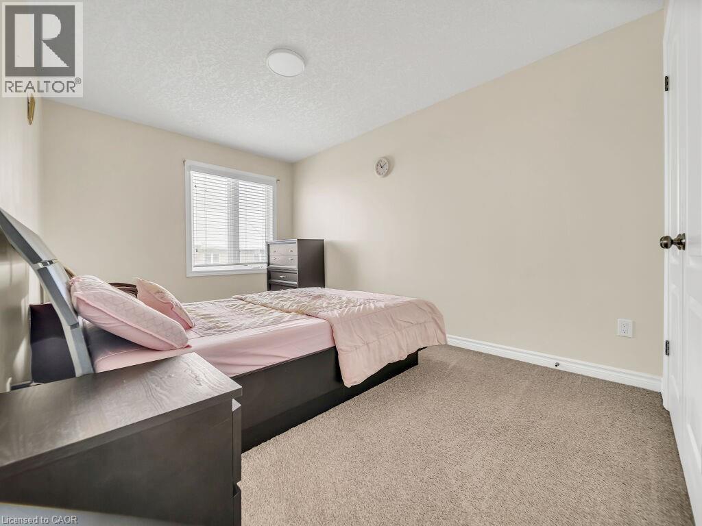 Carpeted bedroom with baseboards and a textured ceiling - 29 Amsterdam Crescent, Guelph, ON - Indoor Photo Showing Bedroom