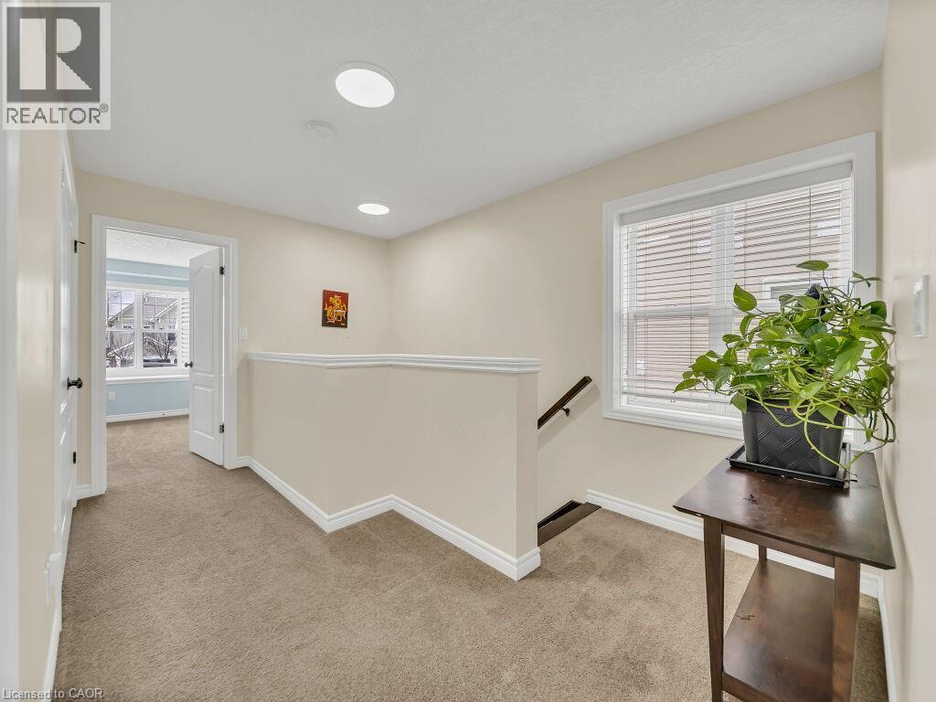 Corridor with an upstairs landing, light colored carpet, plenty of natural light, and recessed lighting - 29 Amsterdam Crescent, Guelph, ON - Indoor Photo Showing Other Room