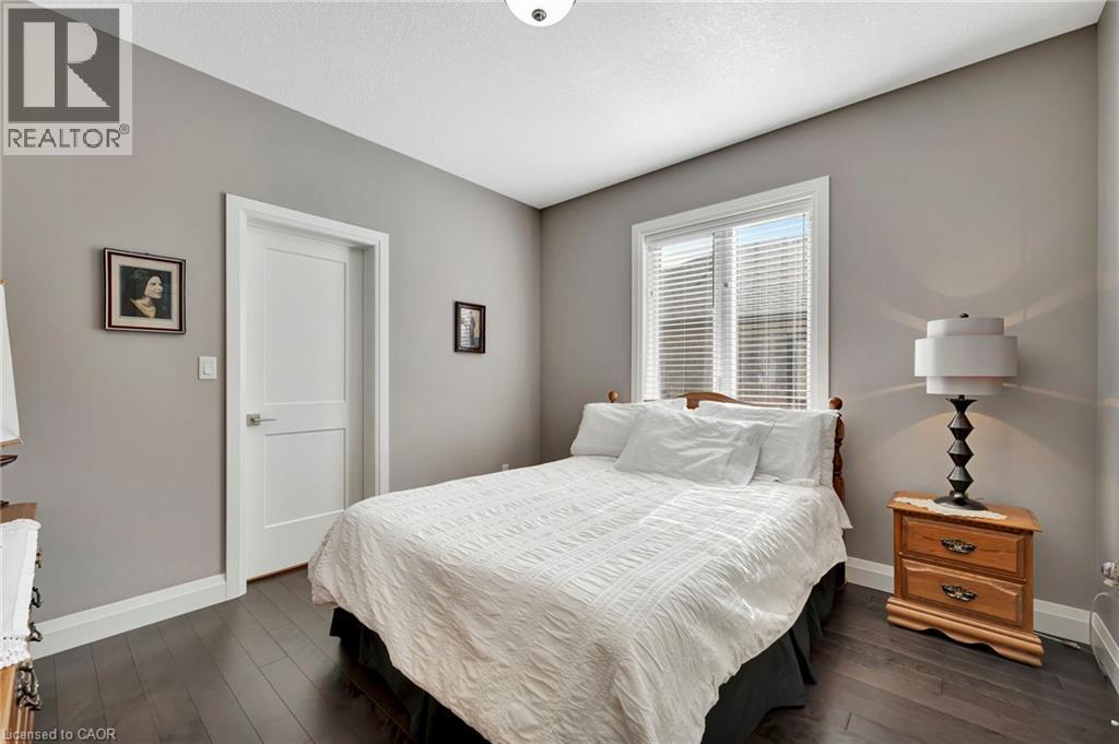 Bedroom featuring baseboards and dark wood finished floors - 107 Forbes Crescent, Listowel, ON - Indoor Photo Showing Bedroom
