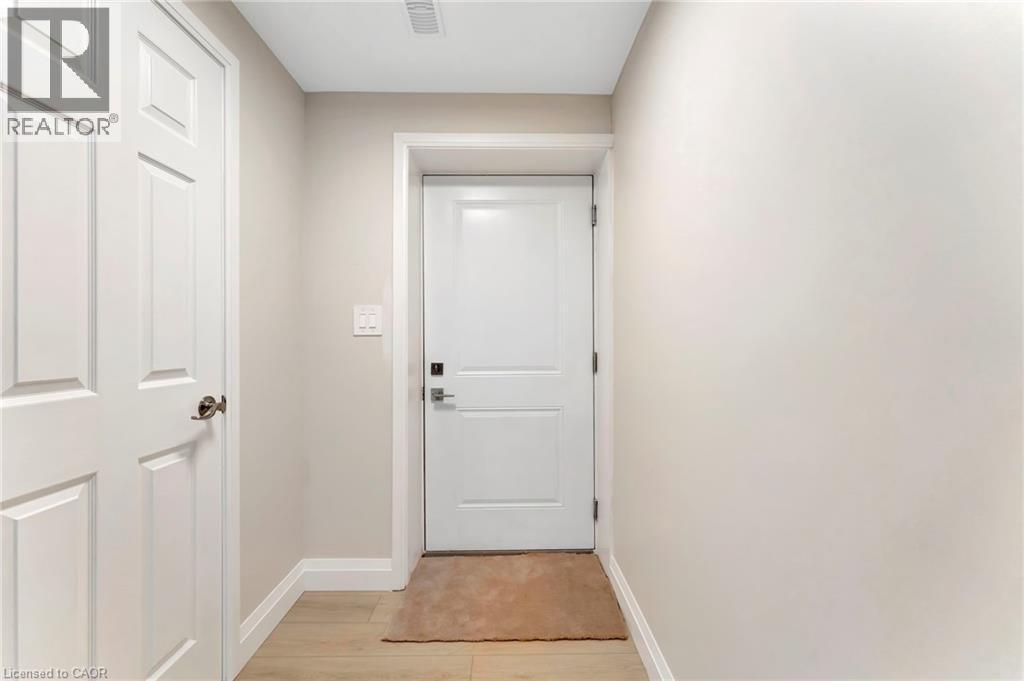 Doorway to outside with baseboards and wood finished floors - 107 Forbes Crescent, Listowel, ON - Indoor Photo Showing Other Room
