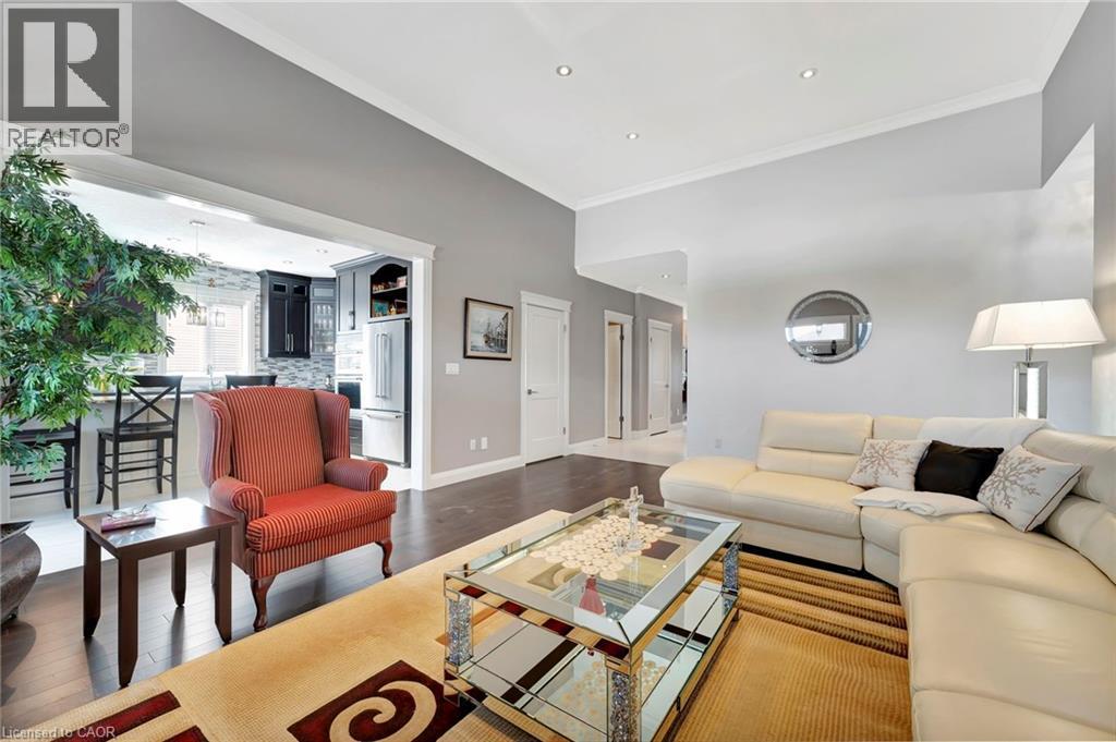 Living room featuring crown molding, wood finished floors, and recessed lighting - 107 Forbes Crescent, Listowel, ON - Indoor Photo Showing Living Room