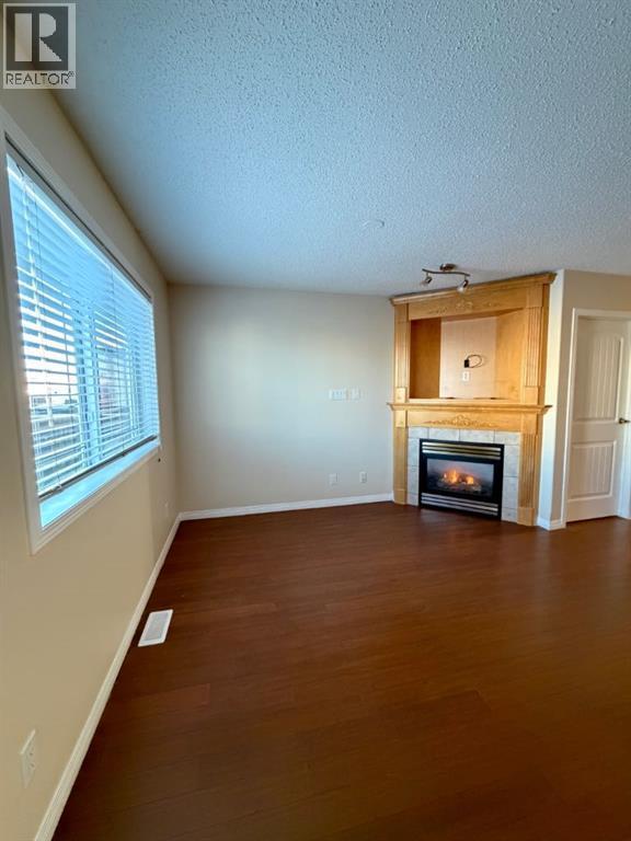 living room - 234 Pacific Crescent, Fort Mcmurray, AB - Indoor With Fireplace
