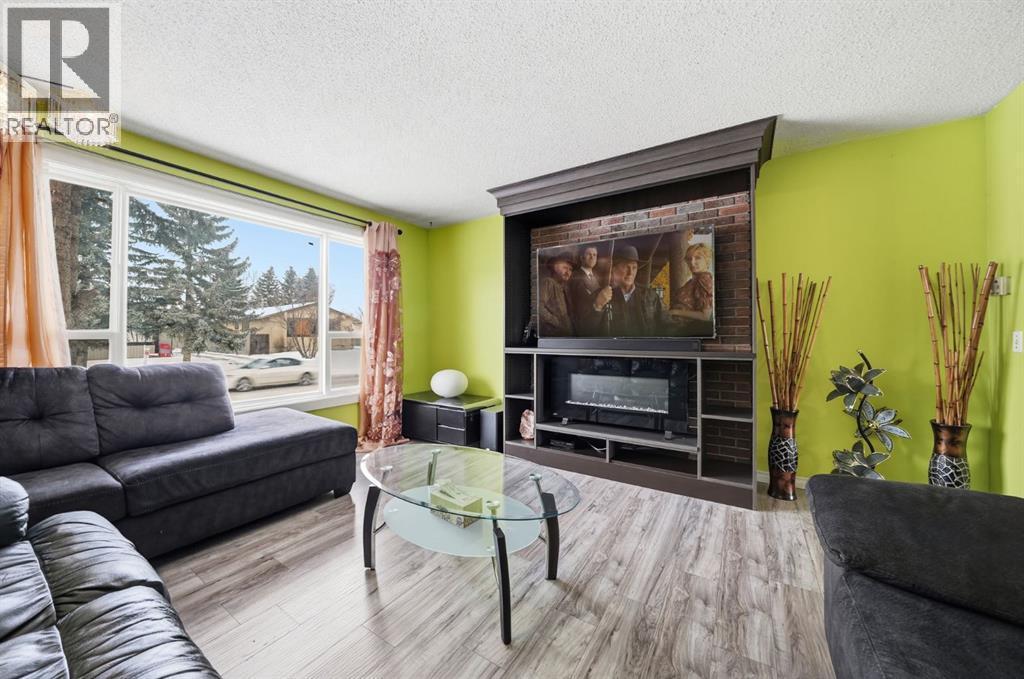 6411 26 Avenue Ne, Calgary, AB - Indoor Photo Showing Living Room With Fireplace