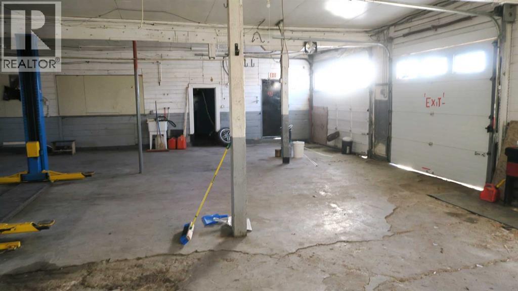 Two Overhead Doors ,#1 - 8 Ft. High 9 Ft. Wide : #2 9 Ft High x 12 Ft Wide - 208 4 Avenue, Gleichen, AB - Indoor Photo Showing Garage