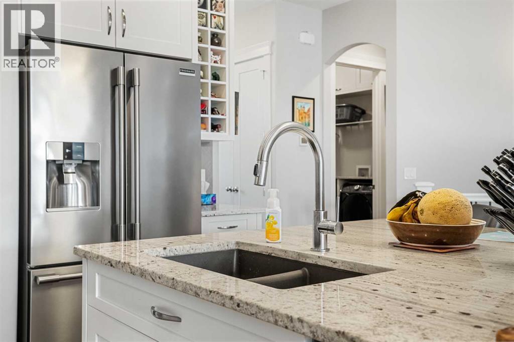 Granite countertops & an undermount sink - 2253 Bayside Road Sw, Airdrie, AB - Indoor Photo Showing Kitchen With Stainless Steel Kitchen With Double Sink With Upgraded Kitchen