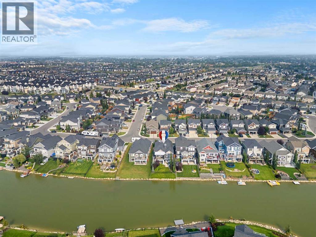 This is a walk-out bungalow backing directly onto the canal with southwest exposure - 2253 Bayside Road Sw, Airdrie, AB - Outdoor With Body Of Water With View