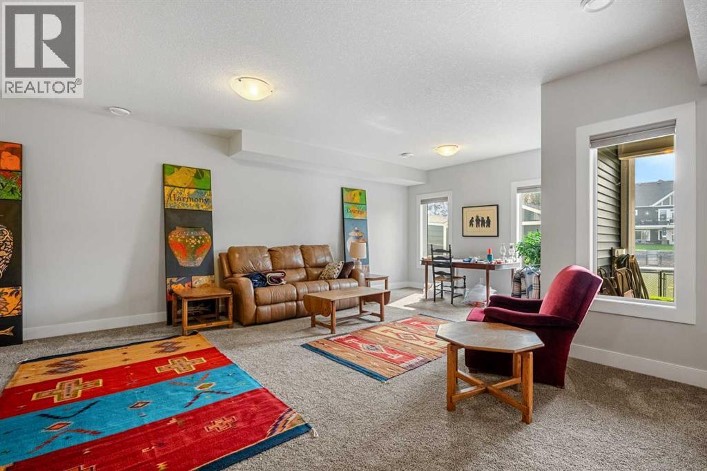 You will love having this additional recreational space - 2253 Bayside Road Sw, Airdrie, AB - Indoor Photo Showing Living Room
