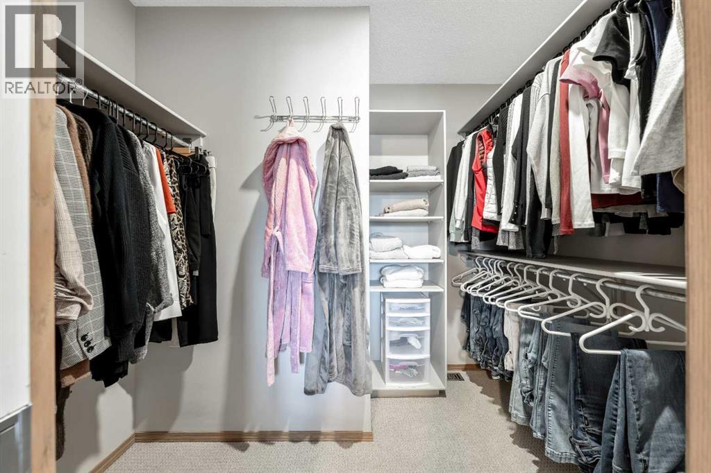 Primary Walk in Closet - 9 Hidden Valley Crescent Nw, Calgary, AB - Indoor With Storage