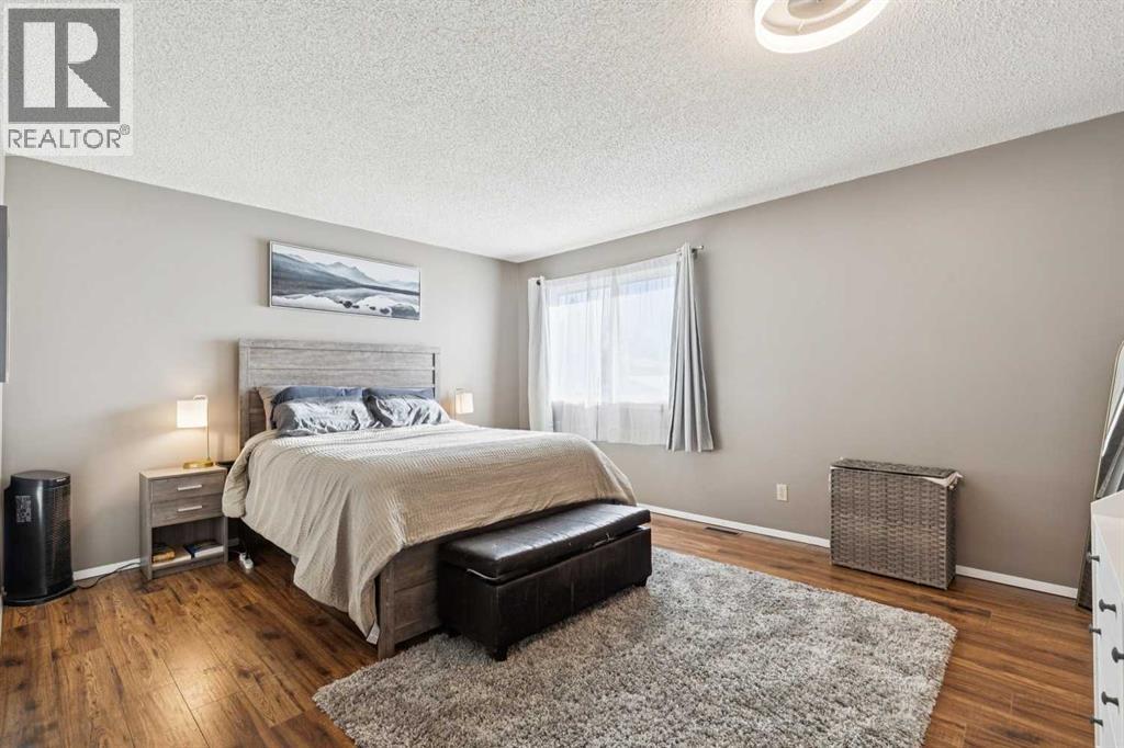 205 Acacia Drive Se, Airdrie, AB - Indoor Photo Showing Bedroom