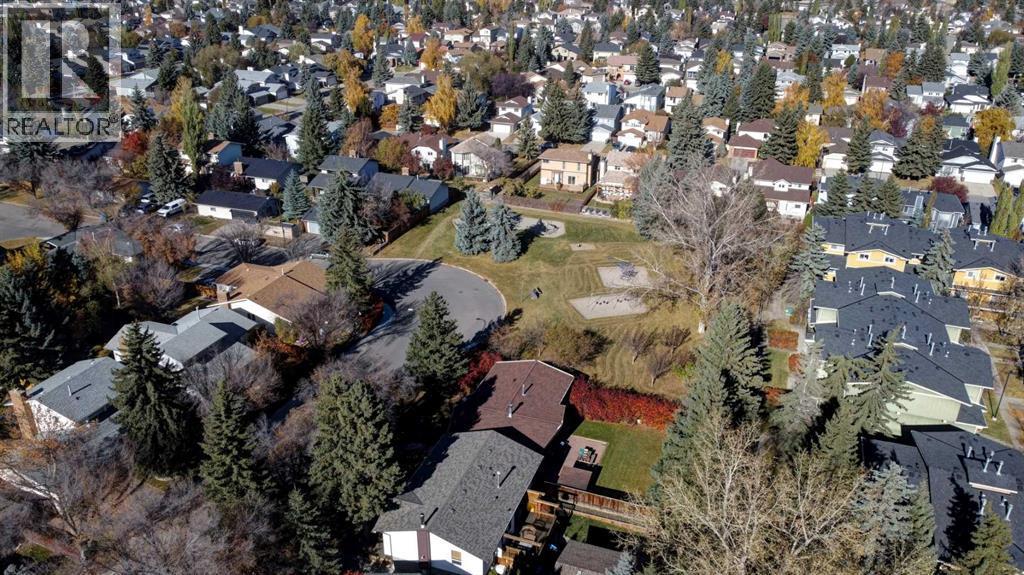 Playground borders Sierra Gardens on the west side - 602, 2200 Woodview Drive Sw, Calgary, AB - Outdoor With View