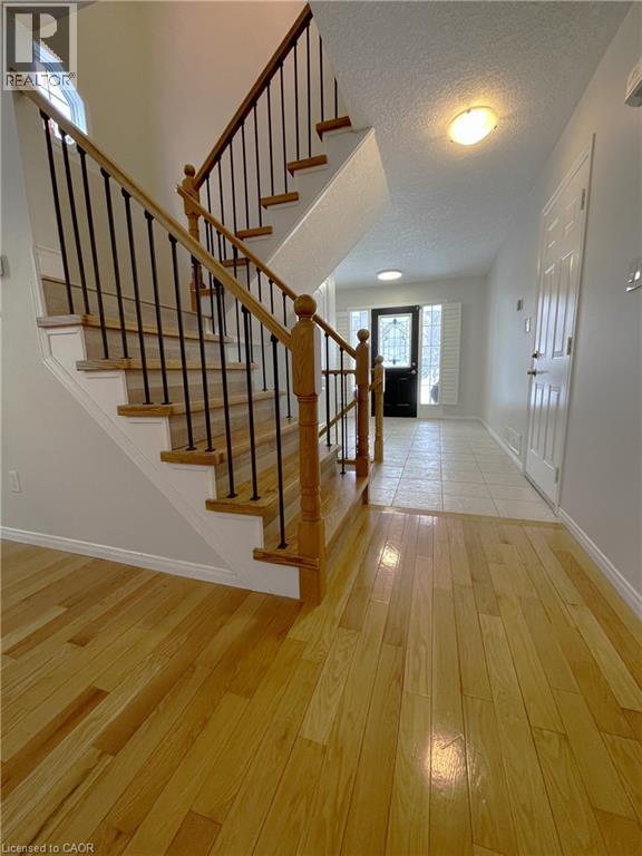 Foyer featuring light wood-style flooring, stairs, and a textured ceiling - 443 Lausanne Crescent, Waterloo, ON - Indoor Photo Showing Other Room