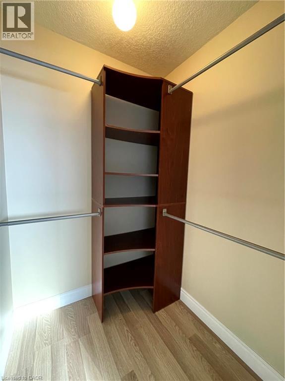 Walk in closet featuring light wood-style flooring - 443 Lausanne Crescent, Waterloo, ON - Indoor Photo Showing Other Room