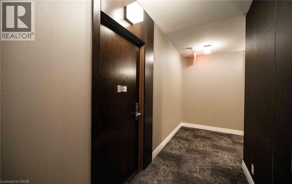 Hallway with dark stone finish floors and baseboards - 50 Absolute Avenue Unit# 2105, Mississauga, ON - Indoor Photo Showing Other Room
