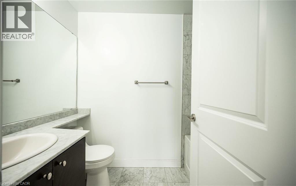 Full bathroom with vanity, washtub / shower combination, and light marble finish floors - 50 Absolute Avenue Unit# 2105, Mississauga, ON - Indoor Photo Showing Bathroom