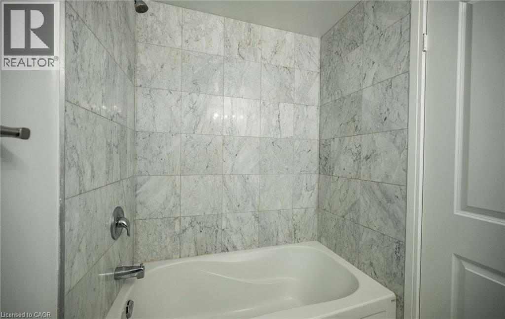 Bathroom featuring bathtub / shower combination - 50 Absolute Avenue Unit# 2105, Mississauga, ON - Indoor Photo Showing Bathroom
