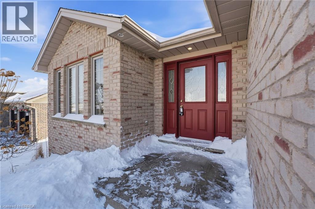 Snow covered property entrance with brick siding - 28 Mansfield Drive, St. George, ON - Outdoor