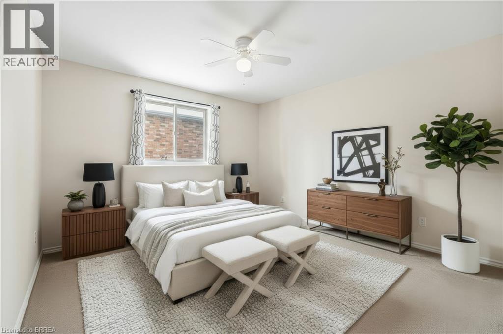 Carpeted bedroom featuring ceiling fan and baseboards - 28 Mansfield Drive, St. George, ON - Indoor Photo Showing Bedroom
