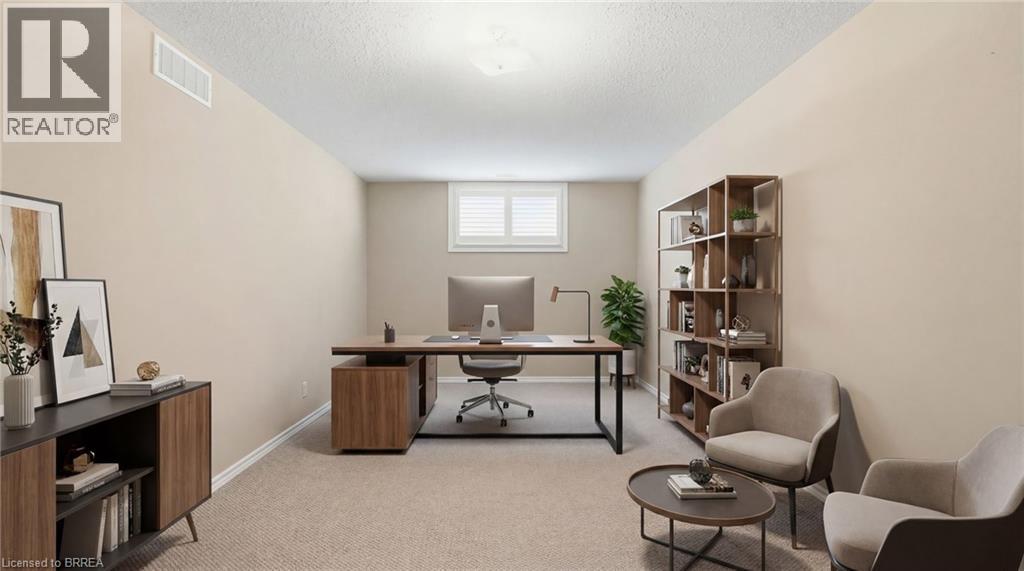 Office space featuring light colored carpet and a textured ceiling - 28 Mansfield Drive, St. George, ON - Indoor