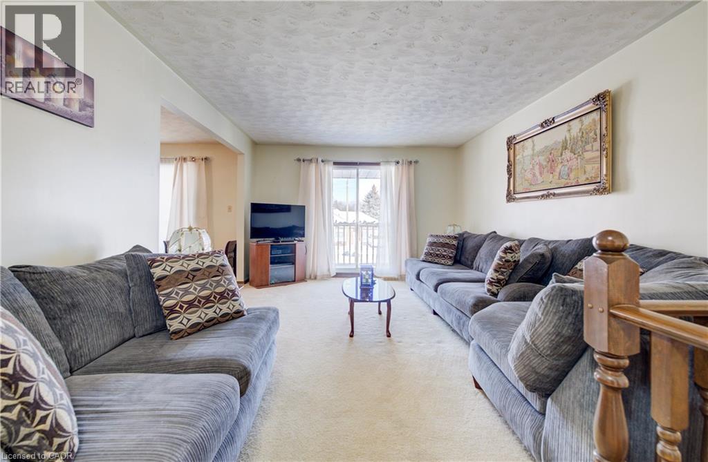 Carpeted living area featuring a textured ceiling - 42 Ruffian Road, Brantford, ON - Indoor Photo Showing Living Room