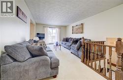 Living room featuring a textured ceiling and carpet flooring -