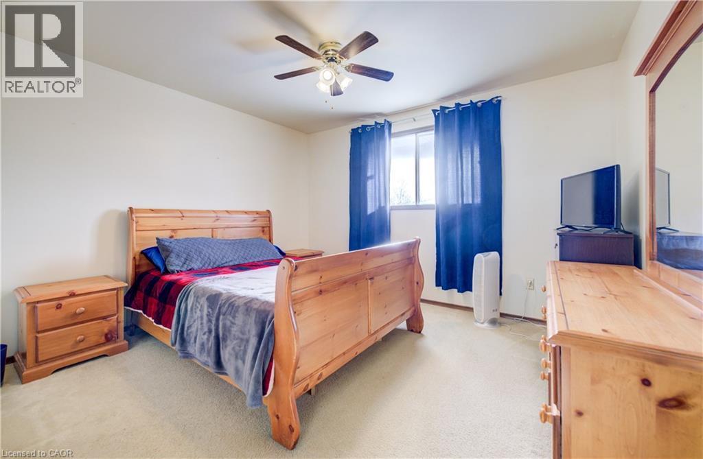 Bedroom 2 with light carpet and a ceiling fan - 42 Ruffian Road, Brantford, ON - Indoor Photo Showing Bedroom