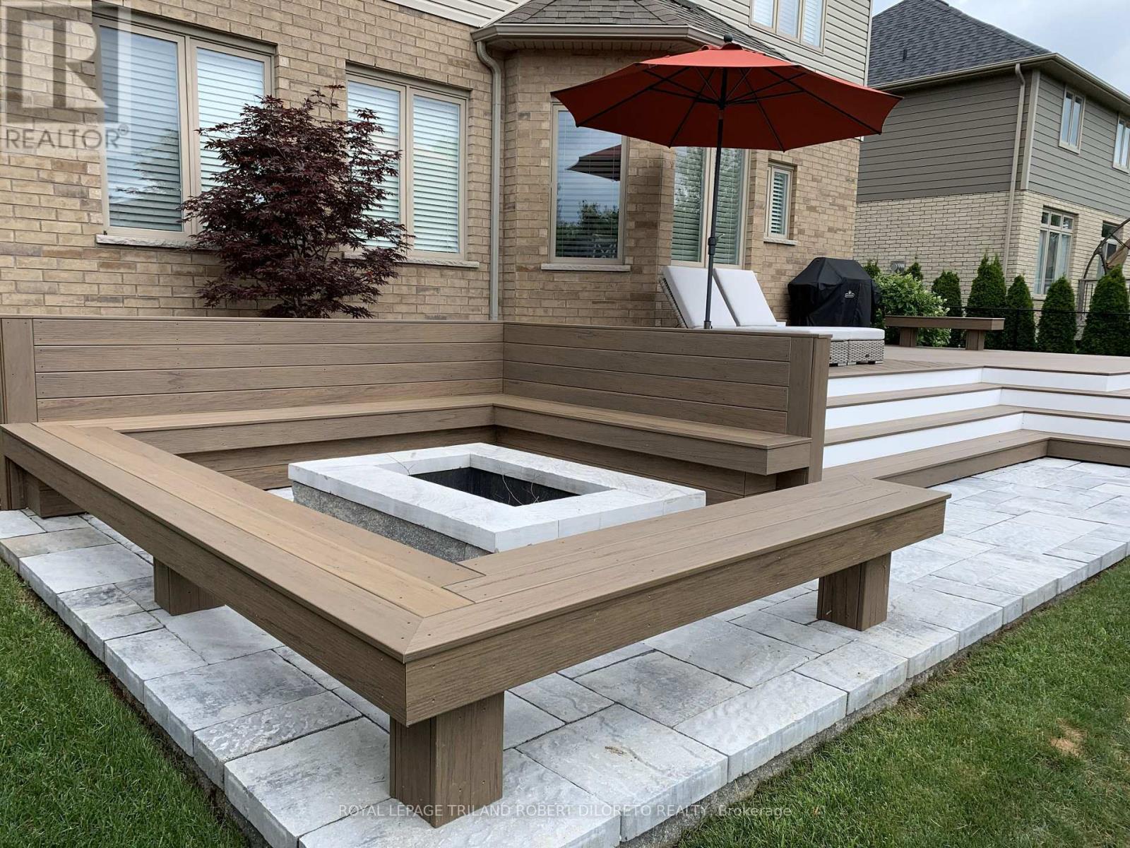 Fire pit with composite bench seating - 2019 - 56 Fieldstone Crescent S, Middlesex Centre (Komoka), ON - Outdoor With Exterior
