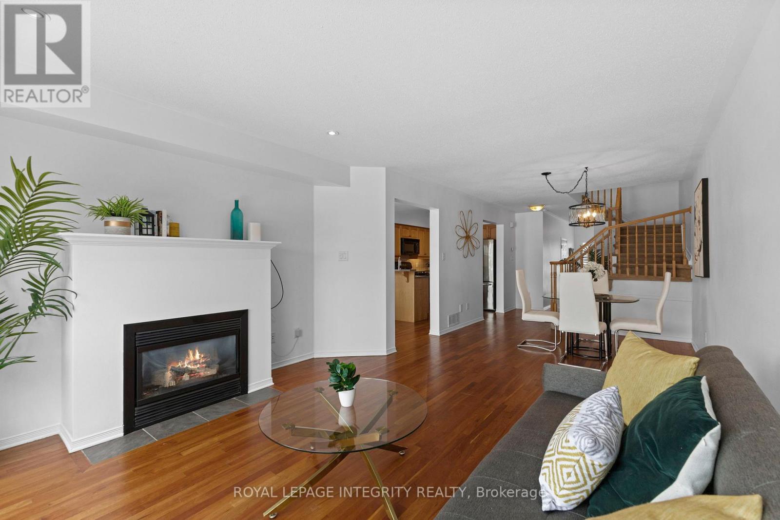 Living room reverse angle - 30 Goldthorpe Private, Ottawa, ON - Indoor Photo Showing Living Room With Fireplace