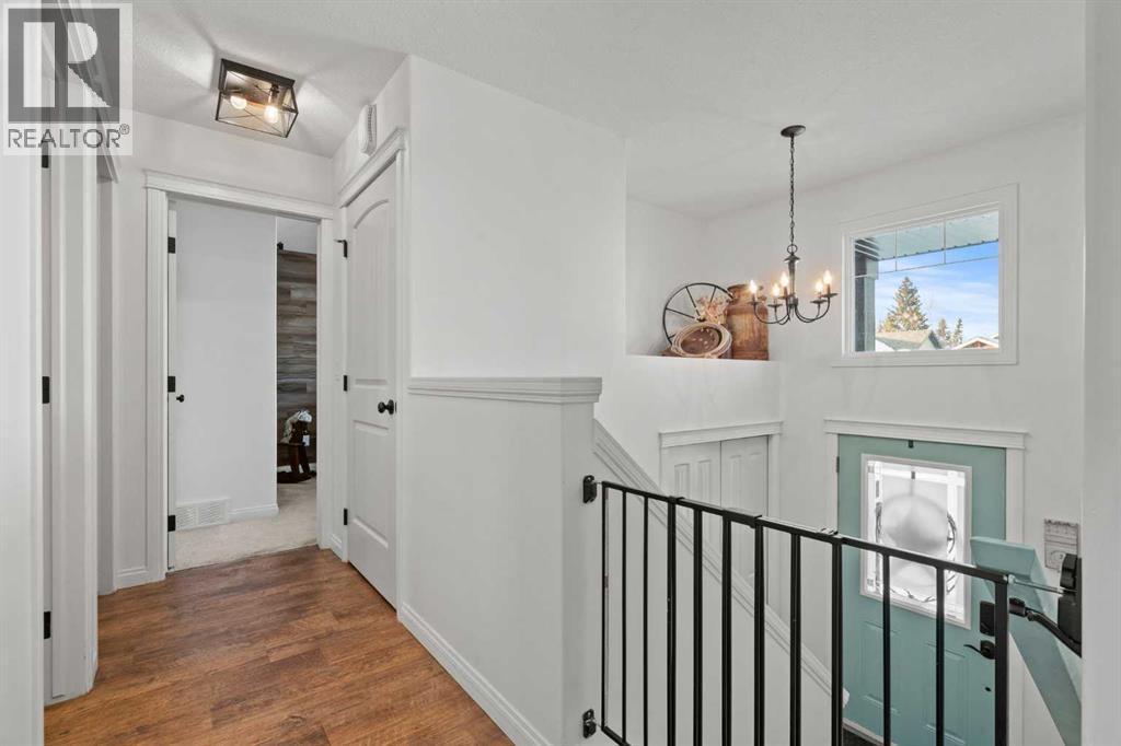 Generous entry with coat closet - 311 Mcleod Crescent, Diamond Valley, AB - Indoor Photo Showing Other Room