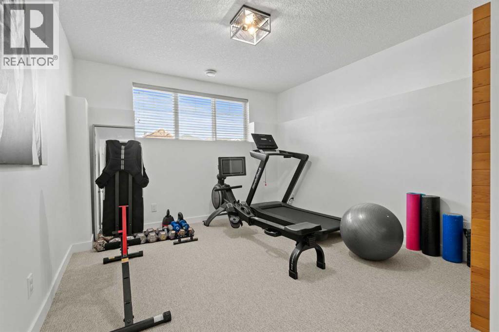 Gym/4th Bedroom - 311 Mcleod Crescent, Diamond Valley, AB - Indoor Photo Showing Gym Room