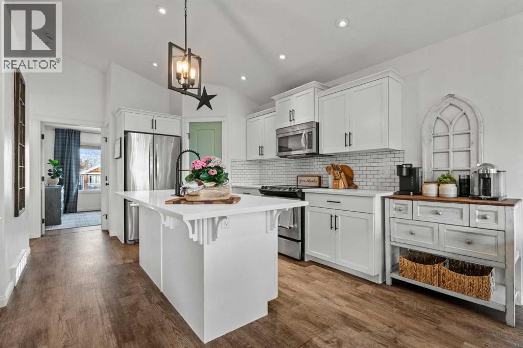 Beautiful kitchen with large island - 311 Mcleod Crescent, Diamond Valley, AB - Indoor Photo Showing Kitchen With Stainless Steel Kitchen With Upgraded Kitchen