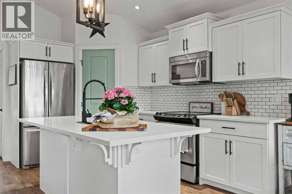 Updated lighting throughout - 311 Mcleod Crescent, Diamond Valley, AB - Indoor Photo Showing Kitchen With Upgraded Kitchen