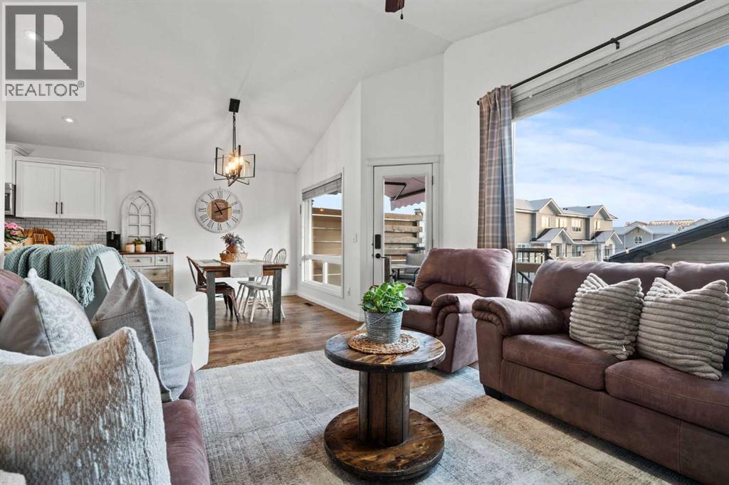 Walk out to balcony - 311 Mcleod Crescent, Diamond Valley, AB - Indoor Photo Showing Living Room