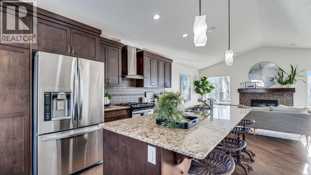389 Cranberry Circle Se, Calgary, AB - Indoor Photo Showing Kitchen With Fireplace With Upgraded Kitchen