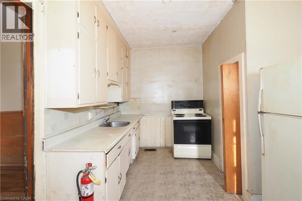 Kitchen featuring light countertops, white appliances, light flooring, and white cabinetry - 37 Northumberland Street, Ayr, ON - Indoor