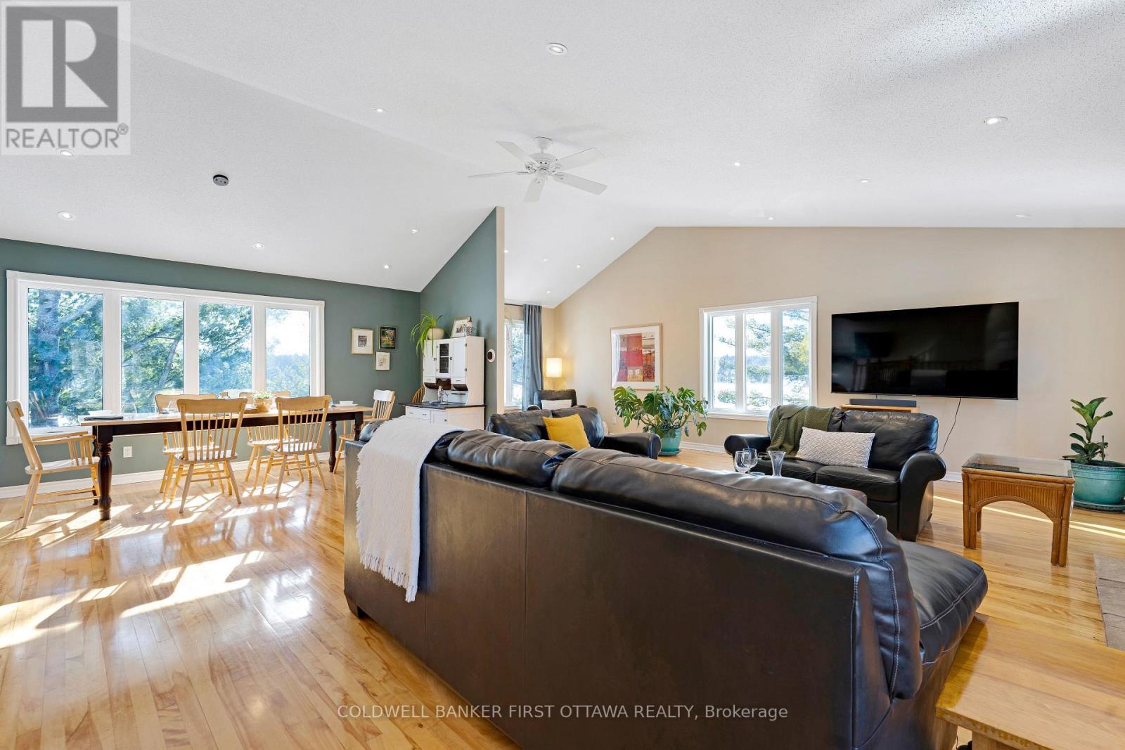 Sun light reflects off hardwood floors - 100 Nagle Way, Tay Valley, ON - Indoor Photo Showing Living Room