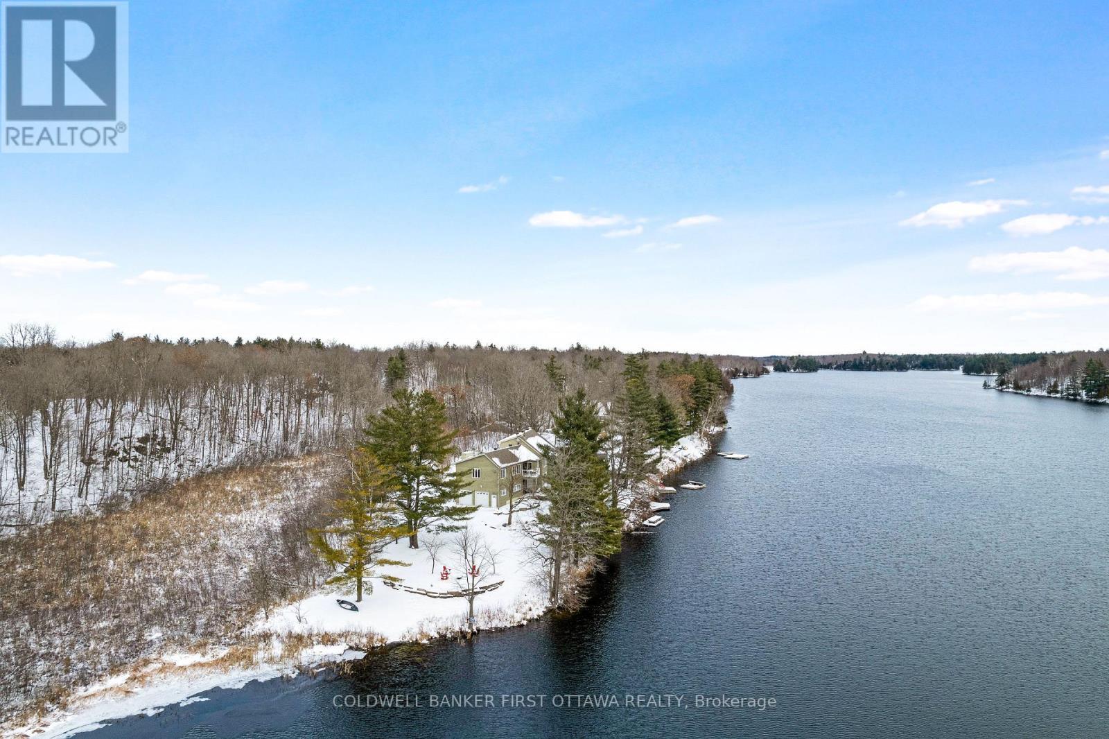 Setting is 7 acres of tranquil woodlands - 100 Nagle Way, Tay Valley, ON - Outdoor With Body Of Water With View