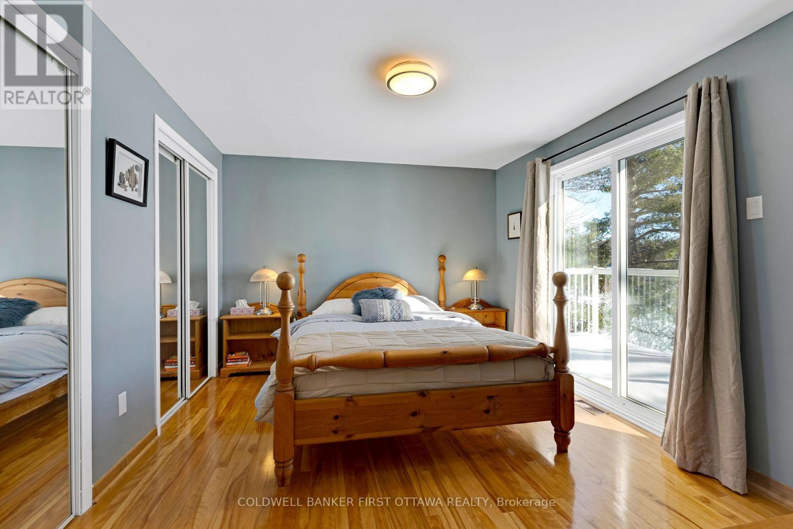 Lower level, home's 5th bedroom - with balcony - 100 Nagle Way, Tay Valley, ON - Indoor Photo Showing Bedroom