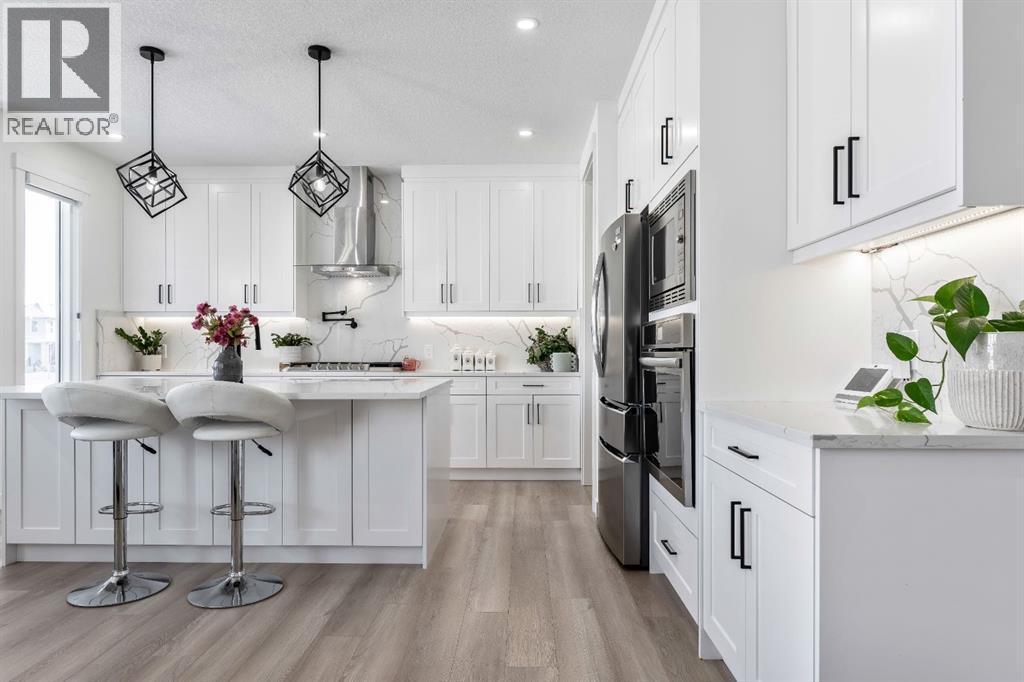 Quartz Countertops - 27 Bridges Drive, Langdon, AB - Indoor Photo Showing Kitchen With Stainless Steel Kitchen With Upgraded Kitchen